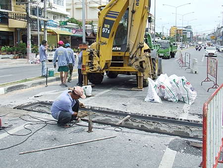 Workers from Pattaya’s Engineering Department repair the sunken drain in Jomtien.